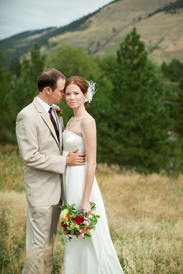 beautiful bride in ivory a line wedding gown with groom in tan